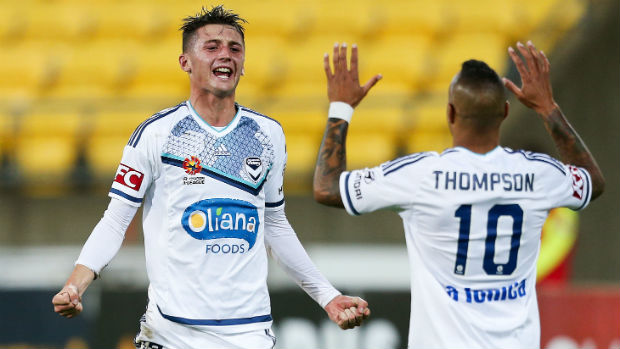 George Howard and Archie Thompson celebrate combining for Victory's fourth goal against Wellington.