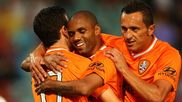 Henrique celebrates with Roar teammates after scoring against the Wanderers.