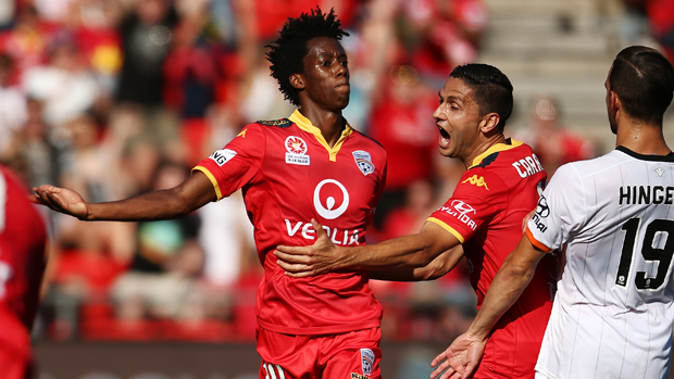 Bruce Kamau celebrates after scoring the opener in Adelaide's 3-0 win over the Roar.