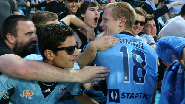 Matt Simon is congratulated by Sydney FC's travelling supporters.